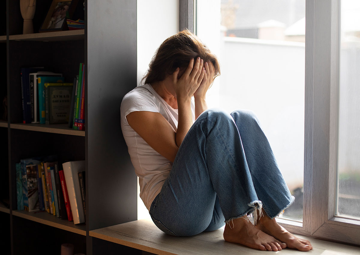 a women sitting on the floor suffering from depression needing treatment in long island, ny